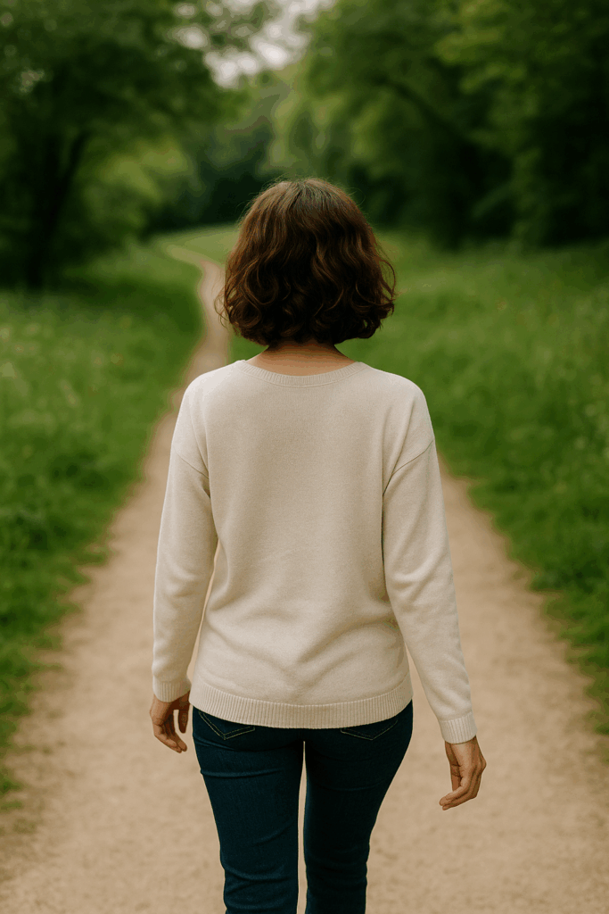 A woman walking peacefully in nature, representing gentle weight loss and soulful self-care in 2025